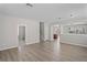 Spacious living room with wood-look floors and a view of the staircase at 18837 Litzau Ln, Land O Lakes, FL 34638