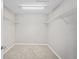 Walk-in closet features overhead lighting and metal shelving for organization at 18837 Litzau Ln, Land O Lakes, FL 34638