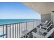 Enjoy ocean views from this condo's balcony featuring comfortable seating and a white picket railing at 19418 Gulf Blvd # 507, Indian Shores, FL 33785