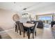 Dining area with modern lighting fixtures and ocean views beyond the living area at 19418 Gulf Blvd # 507, Indian Shores, FL 33785