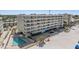 Multi-story condominium with balconies overlooking a beach and pool with beachside access at 19418 Gulf Blvd # 507, Indian Shores, FL 33785
