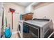 Laundry room featuring a washer, dryer, and storage shelves for convenience at 19418 Gulf Blvd # 507, Indian Shores, FL 33785