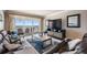 Well-appointed living room with comfortable seating and sliding doors leading to a private balcony with ocean views at 19418 Gulf Blvd # 507, Indian Shores, FL 33785