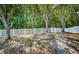 Fenced backyard featuring mature trees with a tree swing at 19610 Sunset Bay Dr, Land O Lakes, FL 34638