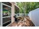 Back patio featuring a grill and views of the fenced backyard with mature trees at 19610 Sunset Bay Dr, Land O Lakes, FL 34638