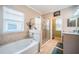 Bright bathroom with glass shower, soaker tub, tile flooring and natural light at 19610 Sunset Bay Dr, Land O Lakes, FL 34638