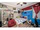 Unique bedroom with themed decor, laminate flooring, and a ceiling fan at 19610 Sunset Bay Dr, Land O Lakes, FL 34638