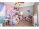 bedroom featuring themed decor, laminate flooring, and a ceiling fan at 19610 Sunset Bay Dr, Land O Lakes, FL 34638