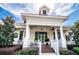 Front view of the pristine white clubhouse, showcasing its inviting entrance and manicured landscaping at 19610 Sunset Bay Dr, Land O Lakes, FL 34638