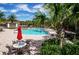 Resort-style community pool area with palm trees, lounge chairs, and umbrellas for a relaxing oasis at 19610 Sunset Bay Dr, Land O Lakes, FL 34638