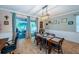 Bright dining area with backyard access includes modern light fixture and built-in shelving at 19610 Sunset Bay Dr, Land O Lakes, FL 34638