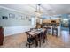 Bright dining area with tile flooring features barstool seating and access to the backyard at 19610 Sunset Bay Dr, Land O Lakes, FL 34638