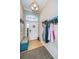 Inviting entryway features a bench, coat rack, and decorative lighting with tile floors at 19610 Sunset Bay Dr, Land O Lakes, FL 34638