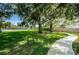 Lush green common area with sidewalks, mature trees and landscaping for community enjoyment at 19610 Sunset Bay Dr, Land O Lakes, FL 34638