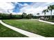 Large, well-manicured green space with walking paths, showcasing community landscaping and amenities at 19610 Sunset Bay Dr, Land O Lakes, FL 34638
