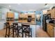 Bright, open kitchen featuring wood cabinets, granite counters, and bar seating for casual dining at 19610 Sunset Bay Dr, Land O Lakes, FL 34638