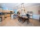 Bright kitchen with tile flooring features island, barstool seating, and a dining area at 19610 Sunset Bay Dr, Land O Lakes, FL 34638