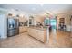 Open eat-in kitchen features stainless fridge, tile flooring, an island, and backyard access at 19610 Sunset Bay Dr, Land O Lakes, FL 34638