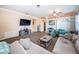 Comfortable living room featuring neutral tones, plush seating, and a decorative bookshelf at 19610 Sunset Bay Dr, Land O Lakes, FL 34638
