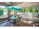 Outdoor patio features brick flooring, an umbrella-covered table, and scenic backyard views at 19610 Sunset Bay Dr, Land O Lakes, FL 34638