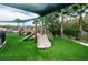 Community playground with multiple slides and climbing features, shaded area and palm tree accents at 19610 Sunset Bay Dr, Land O Lakes, FL 34638