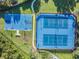 Aerial view of blue basketball and tennis courts in a well-maintained community setting at 19610 Sunset Bay Dr, Land O Lakes, FL 34638