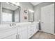Bathroom with a double sink vanity with quartz countertops, dual mirrors, and modern vanity lights at 2817 Cordoba Ranch Blvd, Lutz, FL 33559