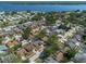 Extensive suburban neighborhood featuring single Gathering homes, foliage, and a lake in the distance at 3039 Sean Way, Palm Harbor, FL 34684