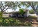 Lush backyard with ample green space, mature trees, and a screened-in patio at 3039 Sean Way, Palm Harbor, FL 34684