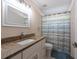 Bathroom featuring a vanity with a granite countertop, a framed mirror, and a shower with a striped curtain at 3039 Sean Way, Palm Harbor, FL 34684