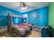Unique bedroom with a house-shaped bunk bed, creating a playful and imaginative space at 3039 Sean Way, Palm Harbor, FL 34684