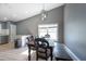 Bright dining area featuring a long wooden table and bench seating beneath a modern pendant light at 3039 Sean Way, Palm Harbor, FL 34684