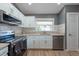 Bright kitchen with stainless steel appliances, white subway tile backsplash, and granite countertops at 3039 Sean Way, Palm Harbor, FL 34684