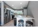 Well-lit kitchen with white cabinets, stainless steel appliances, and a breakfast bar with seating at 3039 Sean Way, Palm Harbor, FL 34684