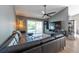 Contemporary living room with wood floors, a black sectional, and sliding glass doors at 3039 Sean Way, Palm Harbor, FL 34684