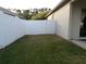 Spacious backyard with well-maintained lawn and secure white vinyl fencing, offering privacy and ample space at 30434 Colehaven Ct, Wesley Chapel, FL 33543
