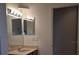 Bathroom featuring a double sink vanity, light fixtures, and tile flooring at 30434 Colehaven Ct, Wesley Chapel, FL 33543