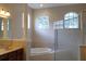 Bright bathroom with garden tub, walk-in shower, and natural light streaming through arched windows at 30434 Colehaven Ct, Wesley Chapel, FL 33543