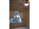 Cozy bedroom with a ceiling fan, crown molding, and a large window at 30434 Colehaven Ct, Wesley Chapel, FL 33543