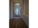 Inviting foyer with a decorative rug, wood floors, and a glass front door at 30434 Colehaven Ct, Wesley Chapel, FL 33543