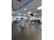 Bright gym featuring treadmills, weightlifting equipment, and wall-mounted TVs at 30434 Colehaven Ct, Wesley Chapel, FL 33543