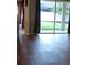 Living area with wood flooring, sliding glass doors with view to outdoor space at 30434 Colehaven Ct, Wesley Chapel, FL 33543