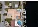 Birds-eye view showcases a waterfront property featuring a pool, private dock, and lush greenery, near a well-maintained street at 3235 Seaway Dr, New Port Richey, FL 34652