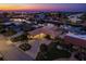 Twilight aerial view showcases an upscale waterfront neighborhood with canal access and beautifully lit homes as the sunsets on the Gulf at 3235 Seaway Dr, New Port Richey, FL 34652