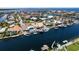 Aerial view of a waterfront community with homes featuring pools and private boat docks along a scenic waterway at 3235 Seaway Dr, New Port Richey, FL 34652