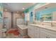 Stylishly designed bathroom with double vanity sinks, walk-in shower, and tub at 3235 Seaway Dr, New Port Richey, FL 34652