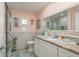 Charming bathroom with marble countertop, white vanity, framed mirror, and a glass-enclosed shower at 3235 Seaway Dr, New Port Richey, FL 34652