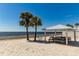 Sandy beach with a shaded pavilion and seating, offering an ideal spot for relaxation and ocean enjoyment at 3235 Seaway Dr, New Port Richey, FL 34652