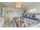 Comfortable bedroom featuring coastal decor, ceiling fan, and light wood-look flooring at 3235 Seaway Dr, New Port Richey, FL 34652