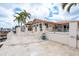 Exterior view of home with boat dock, swimming pool and lush tropical landscaping at 3235 Seaway Dr, New Port Richey, FL 34652
